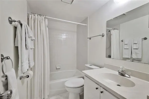 a bathroom with a sink toilet tub and shower