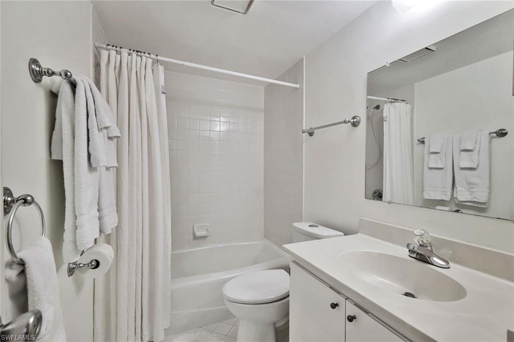 234 Pebble Beach Boulevard, Unit 306 Naples, FL 34113 - Photo 17 of 19 a bathroom with a sink toilet tub and shower