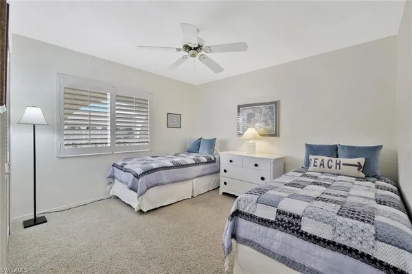a spacious bedroom with a bed and a chandelier