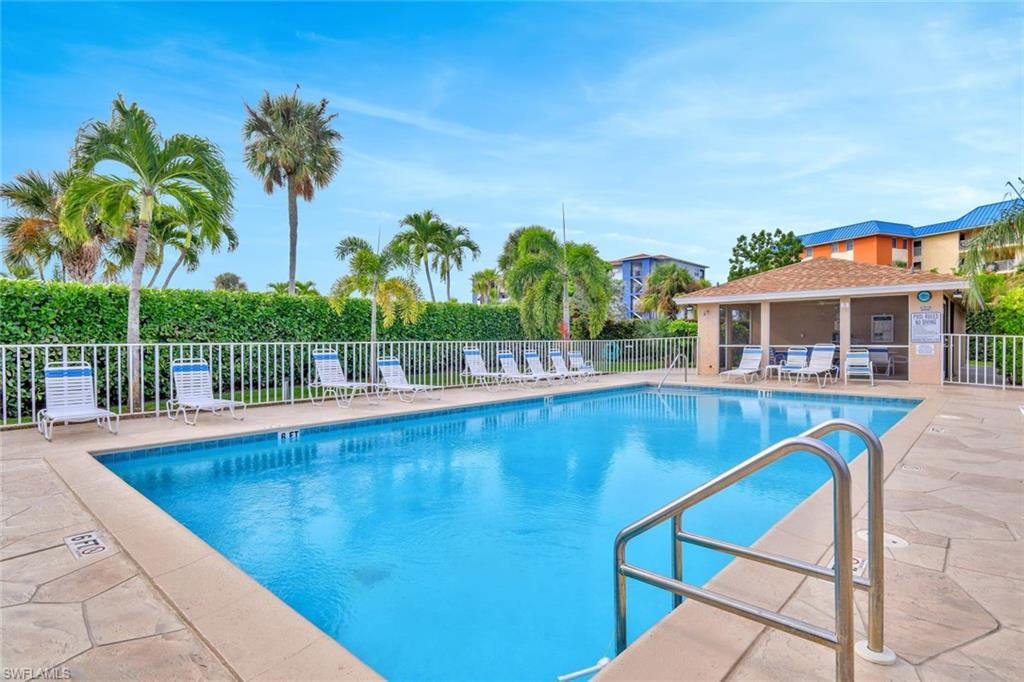 234 Pebble Beach Boulevard, Unit 306 Naples, FL 34113 - Photo 19 of 19 a view of a house with a swimming pool