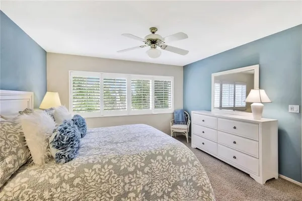 a bed room with a bed and a window
