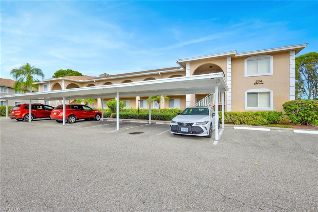 234 Pebble Beach Boulevard, Unit 306 Naples, FL 34113 - Photo 8 of 19 a car parked in front of a house