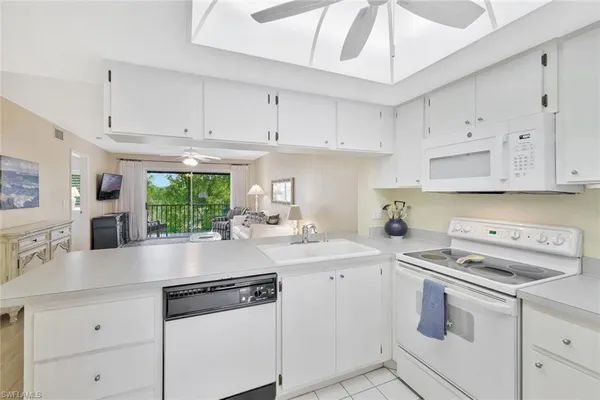 a kitchen with cabinets appliances a sink and a counter top space