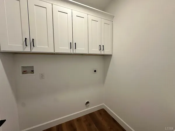 a view of empty room with wooden floor and window