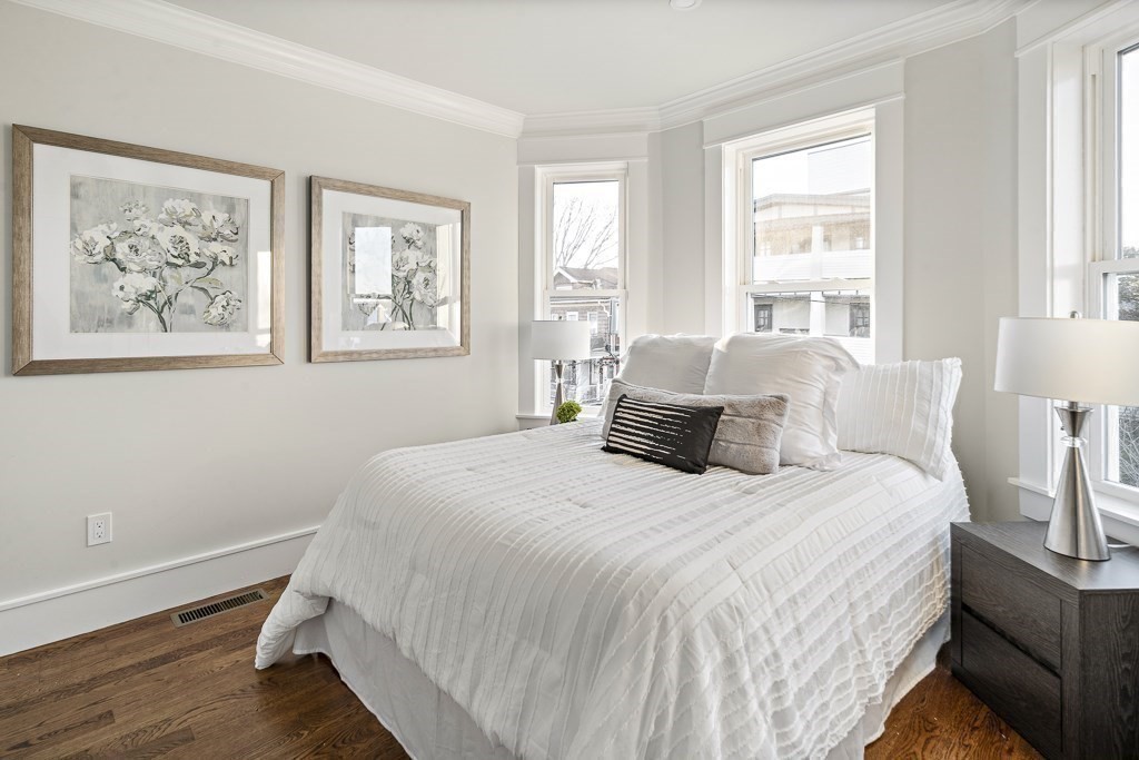 19 Fenwick Street, Unit 4 Somerville, MA 02145 - Photo 17 of 33 a bedroom with a large bed and a window