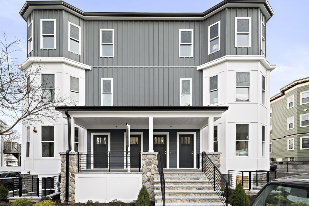 19 Fenwick Street, Unit 4 Somerville, MA 02145 - Photo 2 of 33 a front view of a residential apartment building with a yard