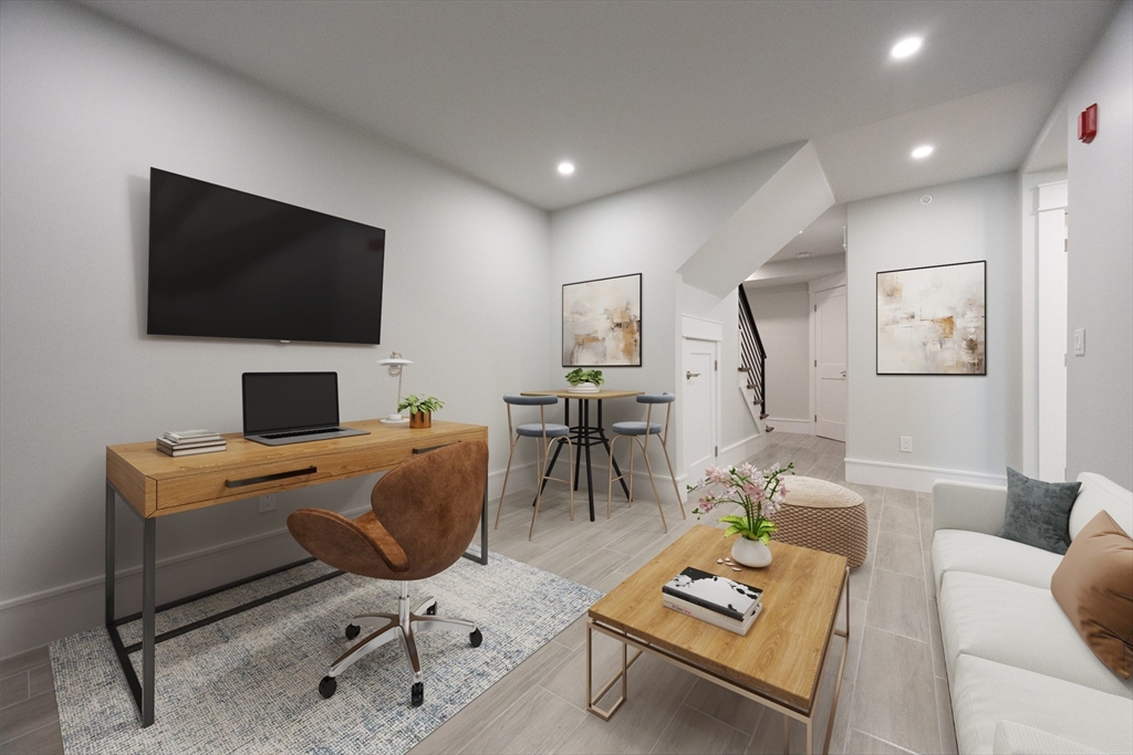 19 Fenwick Street, Unit 4 Somerville, MA 02145 - Photo 22 of 33 a work room with furniture and a flat screen tv