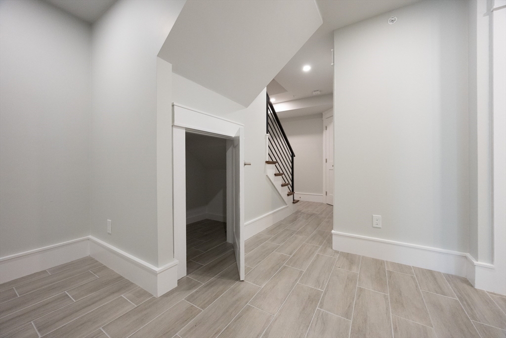 19 Fenwick Street, Unit 4 Somerville, MA 02145 - Photo 26 of 33 a view of a hallway with wooden floor and entryway