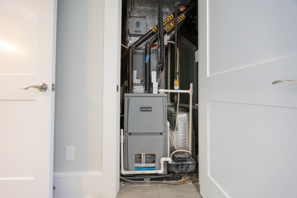 19 Fenwick Street, Unit 4 Somerville, MA 02145 - Photo 30 of 33 a view of walk in closet with clothes and shoes