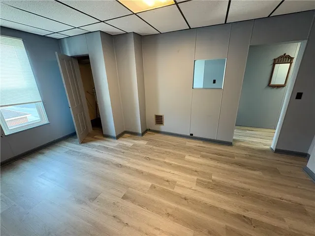 an empty room with wooden floor and closet