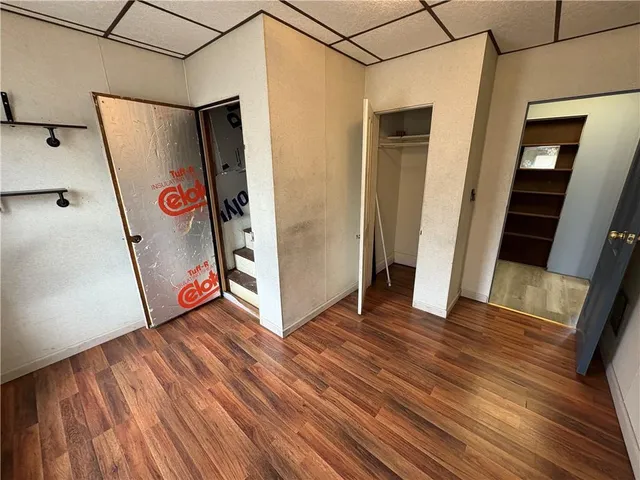 a view of a hallway with wooden floor and entryway
