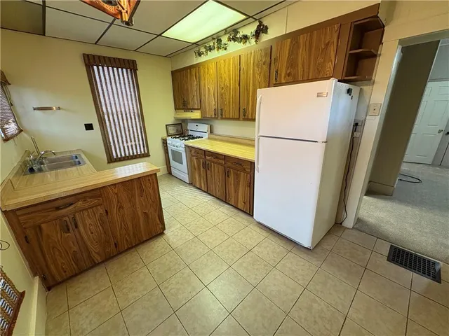 a kitchen with sink cabinets and refrigerator