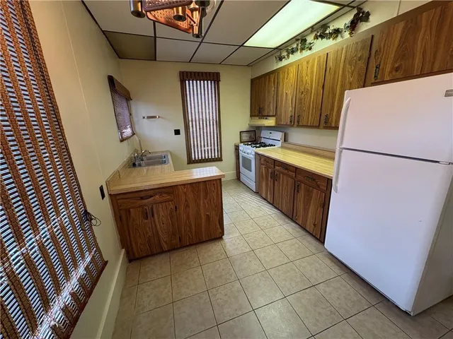 a kitchen with a refrigerator and a sink