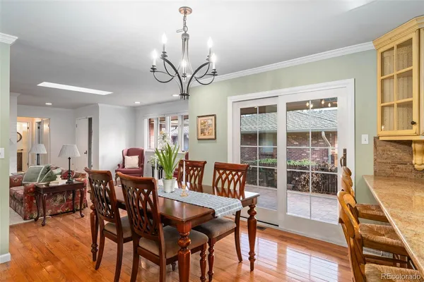 a living room with stainless steel appliances furniture and a kitchen view