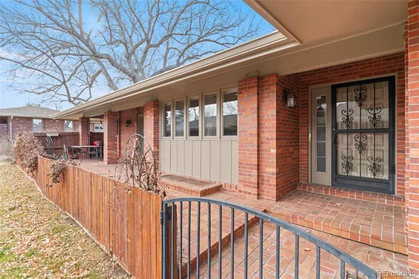 a view of a porch with wooden floor and fence