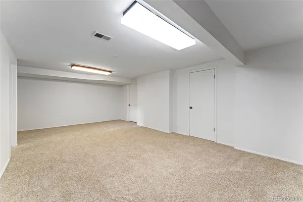 a spacious bedroom with a bed and a cabinets