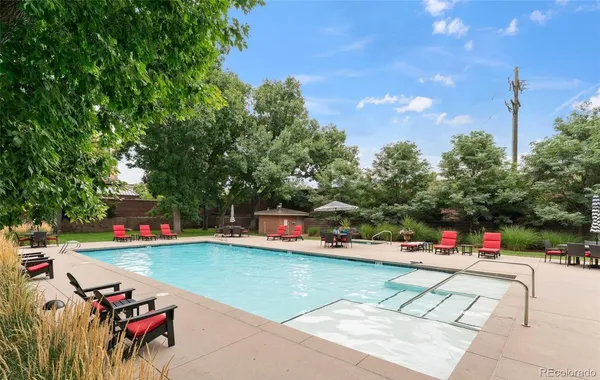 a view of backyard with swimming pool and outdoor seating