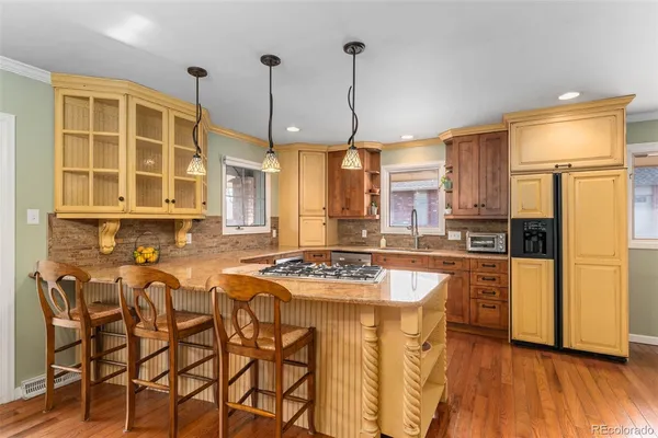 a kitchen with stainless steel appliances a stove a sink and a refrigerator