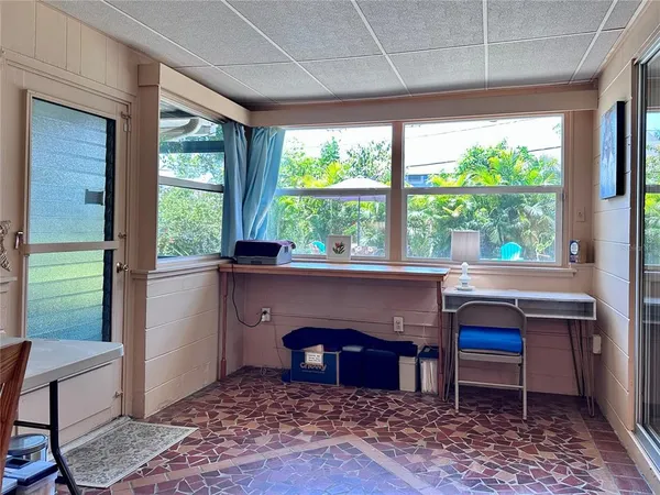a living room with a table chair and a large window