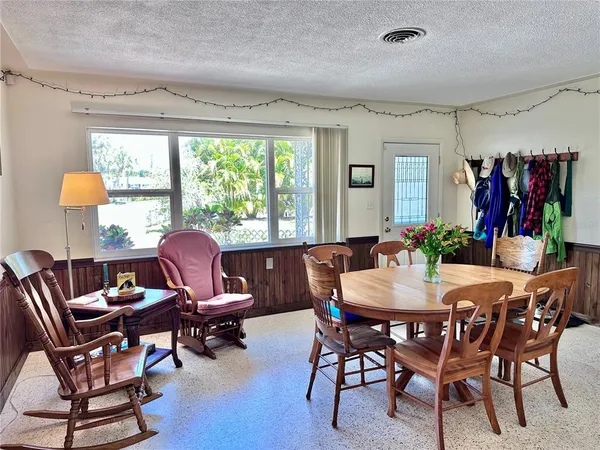 a view of a dining room with furniture window and outside view