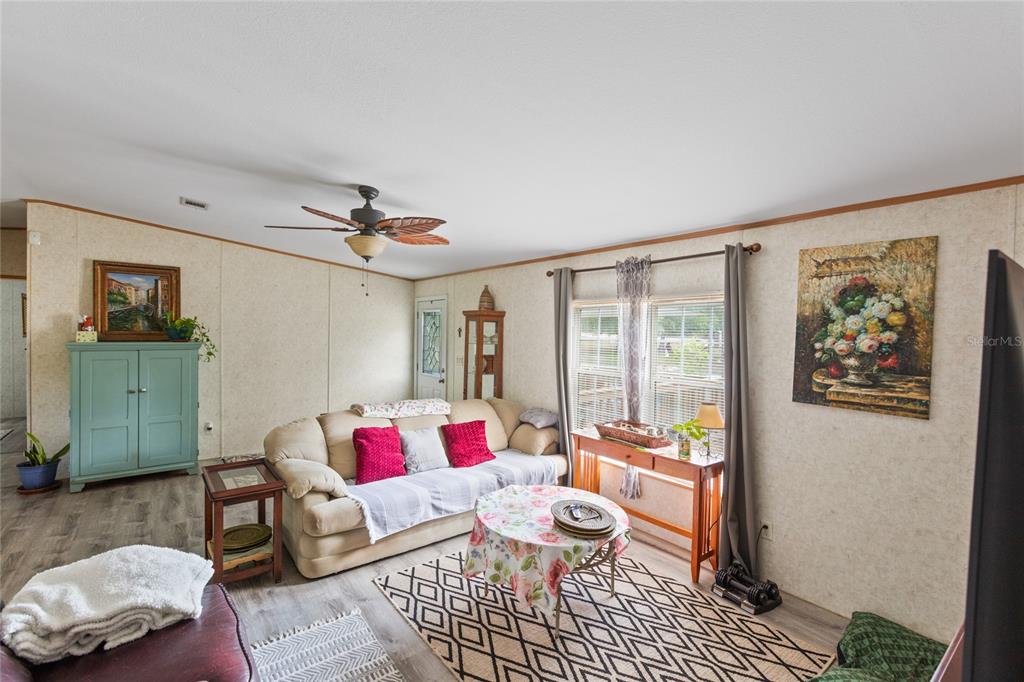 5670 Acadia Street Keystone Heights, FL 32656 - Photo 45 of 65 a living room with furniture and wooden floor