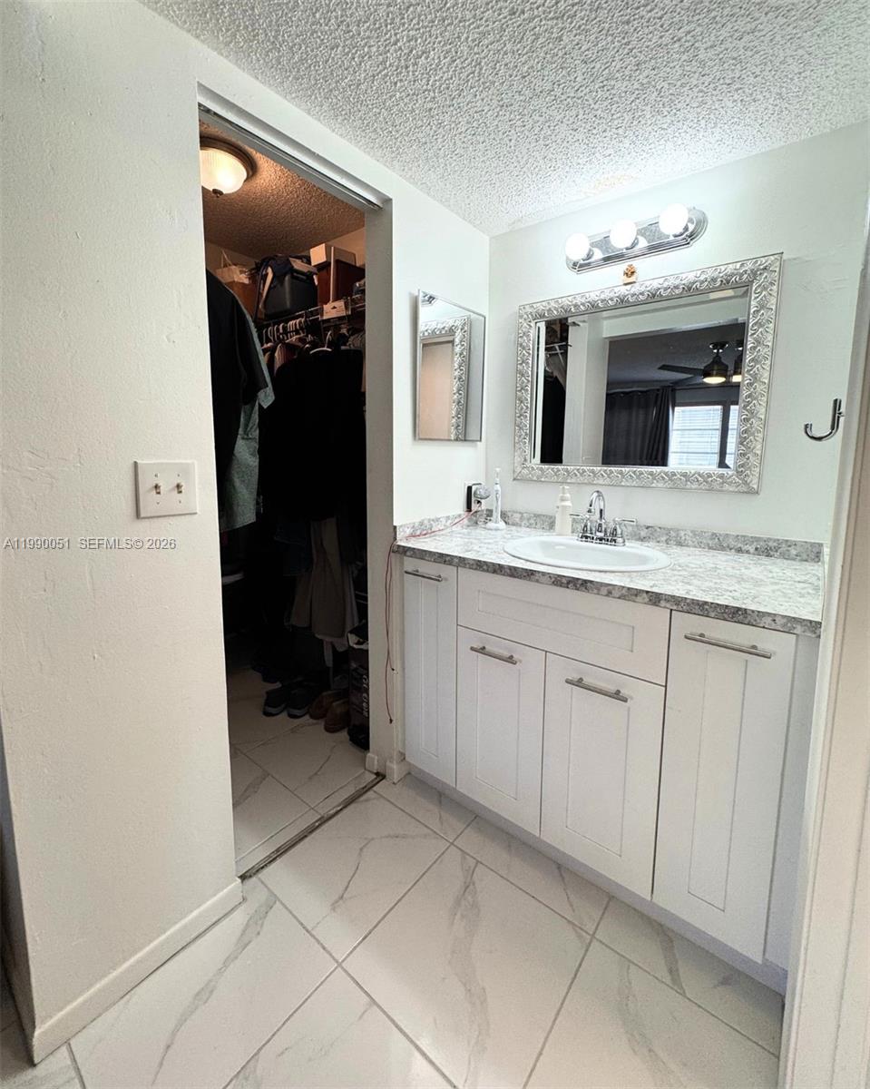 3776 Inverrary Boulevard, Unit 301R Lauderhill, FL 33319 - Photo 11 of 31 a bathroom with a sink and a mirror