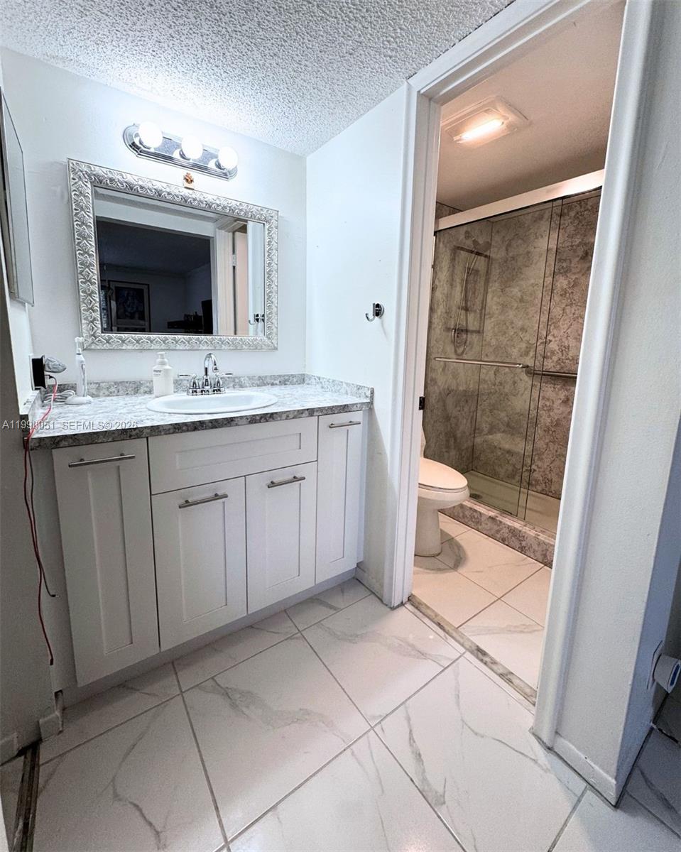 3776 Inverrary Boulevard, Unit 301R Lauderhill, FL 33319 - Photo 13 of 31 a bathroom with a sink and a mirror