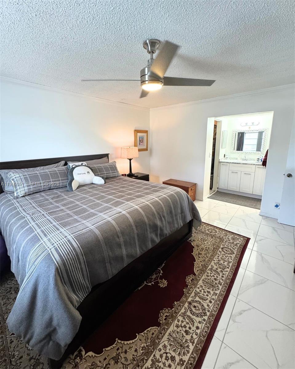 3776 Inverrary Boulevard, Unit 301R Lauderhill, FL 33319 - Photo 15 of 31 a bedroom with a large bed and a dresser