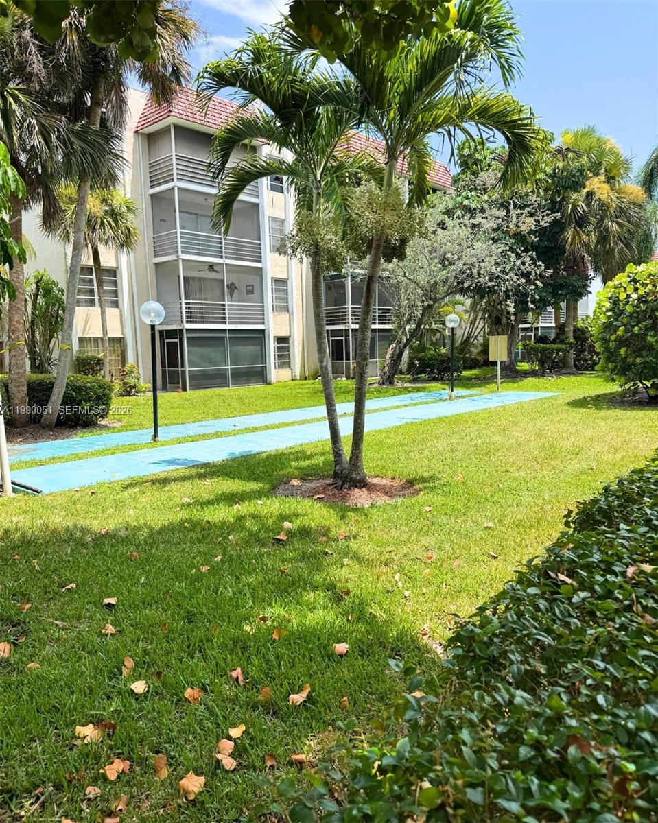 3776 Inverrary Boulevard, Unit 301R Lauderhill, FL 33319 - Photo 16 of 31 a view of a big yard with palm trees
