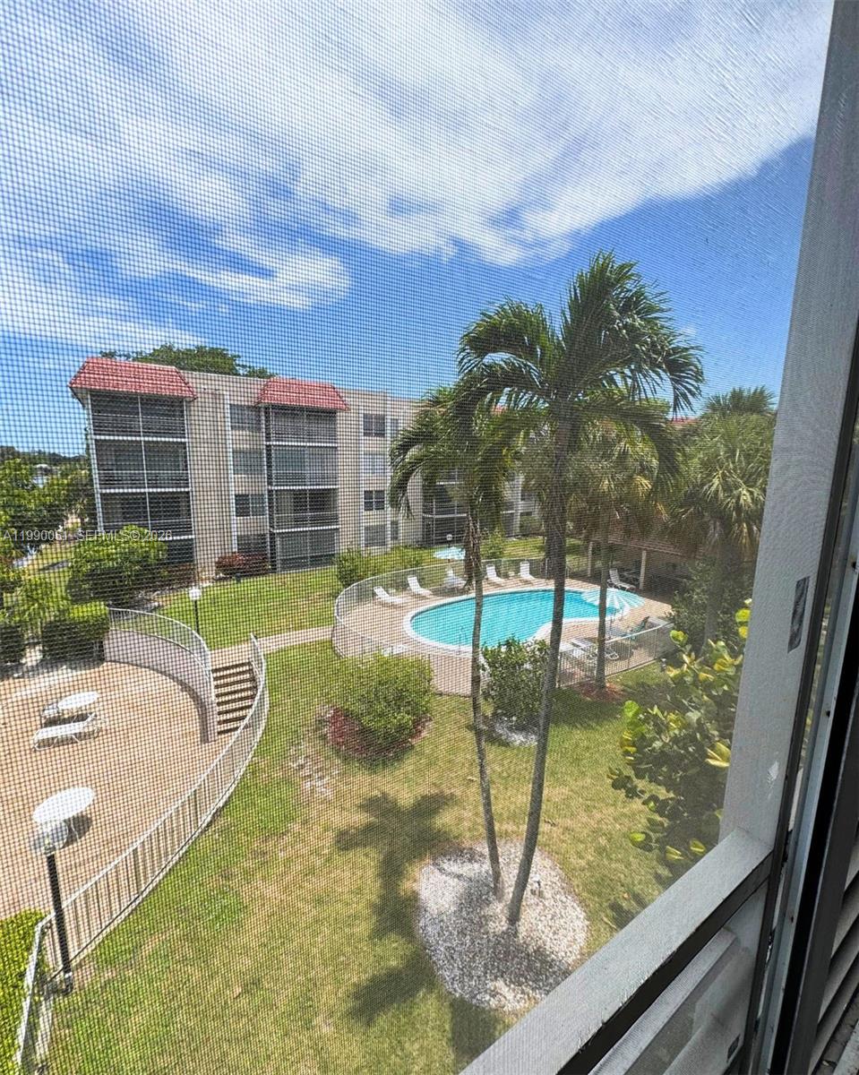 3776 Inverrary Boulevard, Unit 301R Lauderhill, FL 33319 - Photo 20 of 31 a swimming pool with outdoor seating and yard