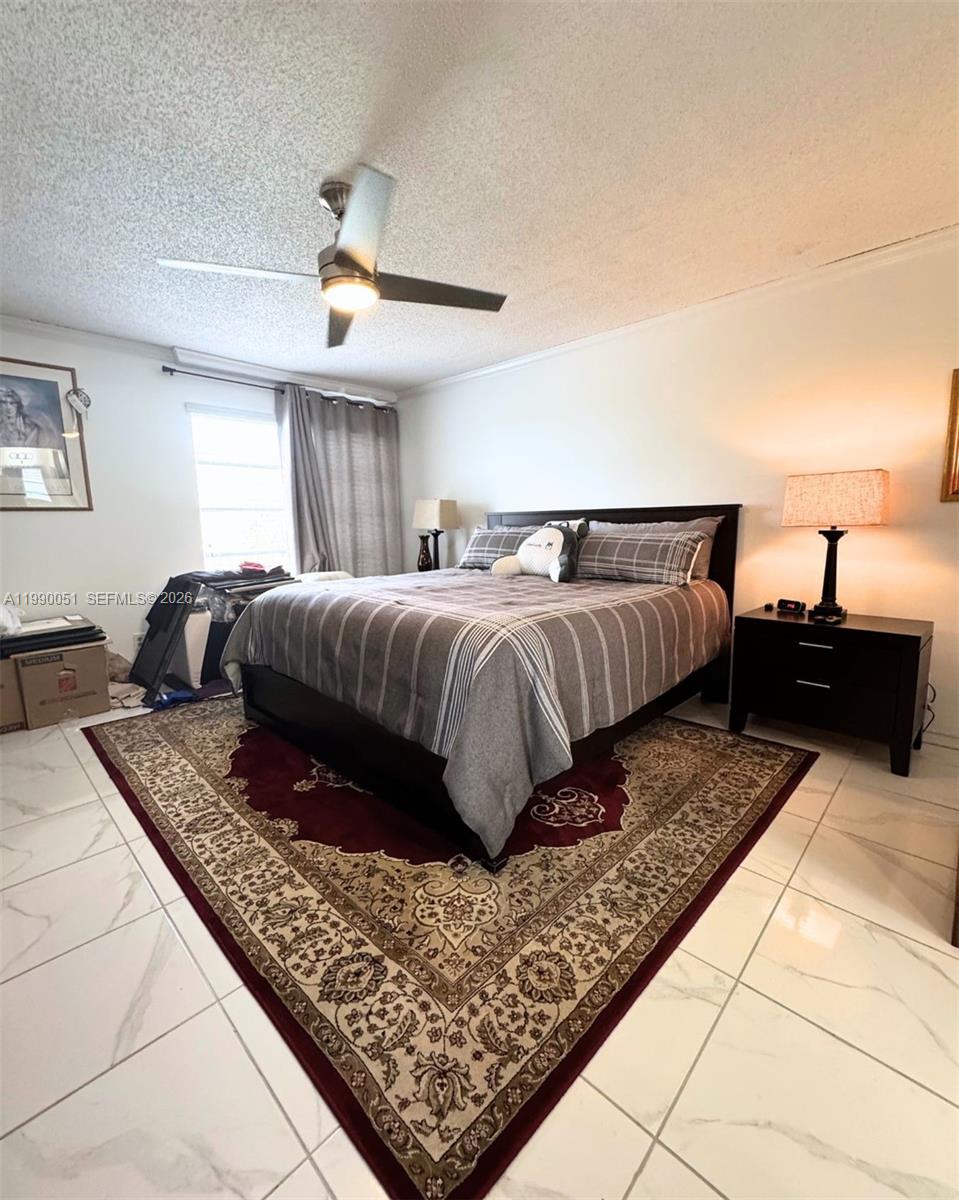 3776 Inverrary Boulevard, Unit 301R Lauderhill, FL 33319 - Photo 22 of 31 a living room with a bed and a couch