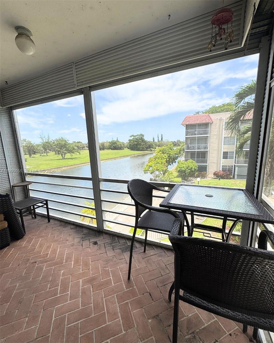 3776 Inverrary Boulevard, Unit 301R Lauderhill, FL 33319 - Photo 28 of 31 a view of a chairs and table in patio with a backyard