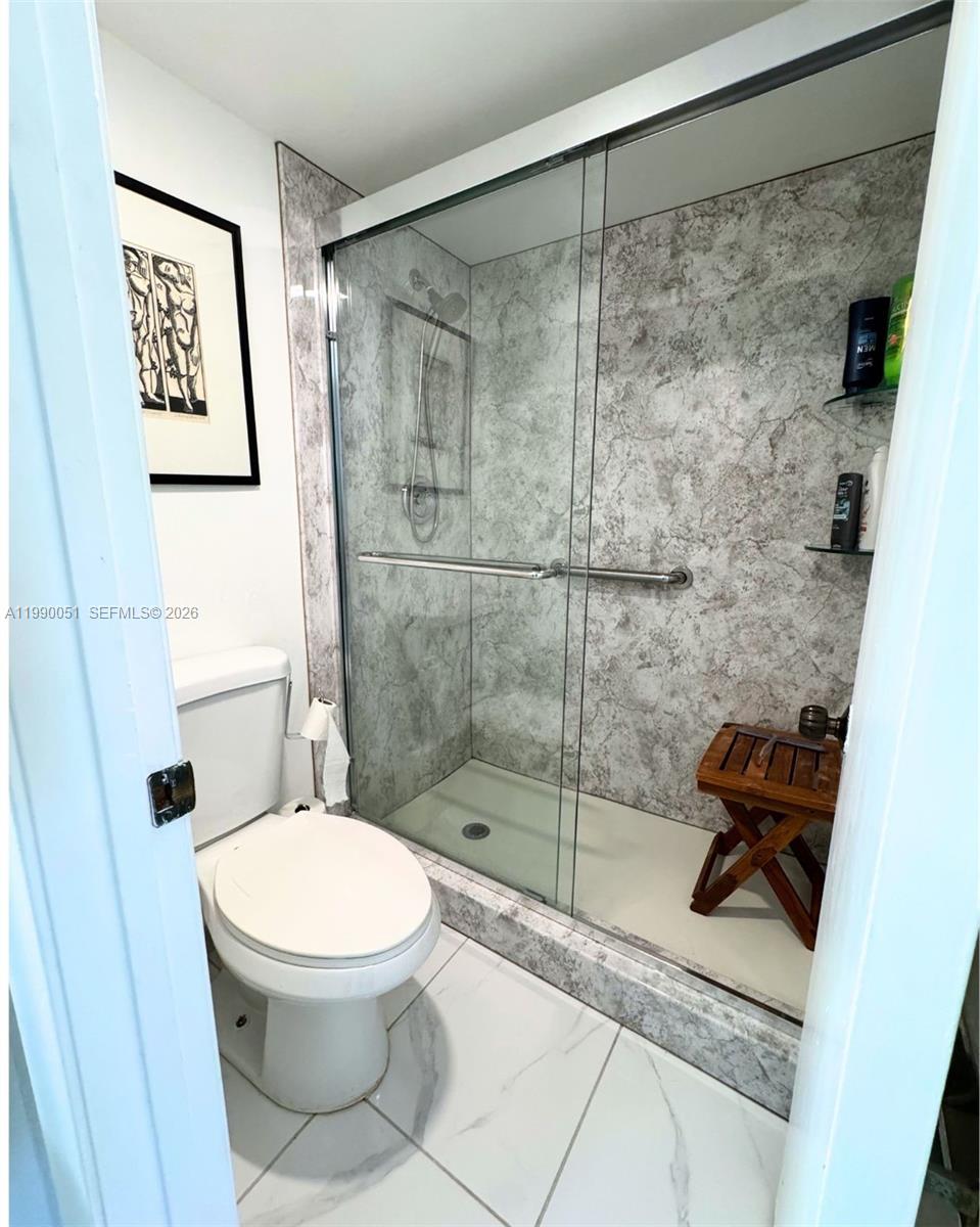 3776 Inverrary Boulevard, Unit 301R Lauderhill, FL 33319 - Photo 29 of 31 a bathroom with a toilet and a shower