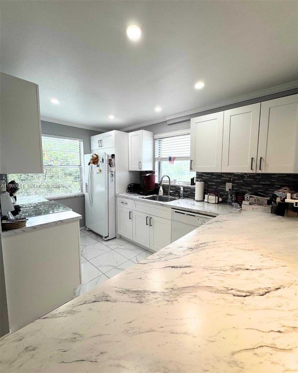 3776 Inverrary Boulevard, Unit 301R Lauderhill, FL 33319 - Photo 3 of 31 a large white kitchen with cabinets