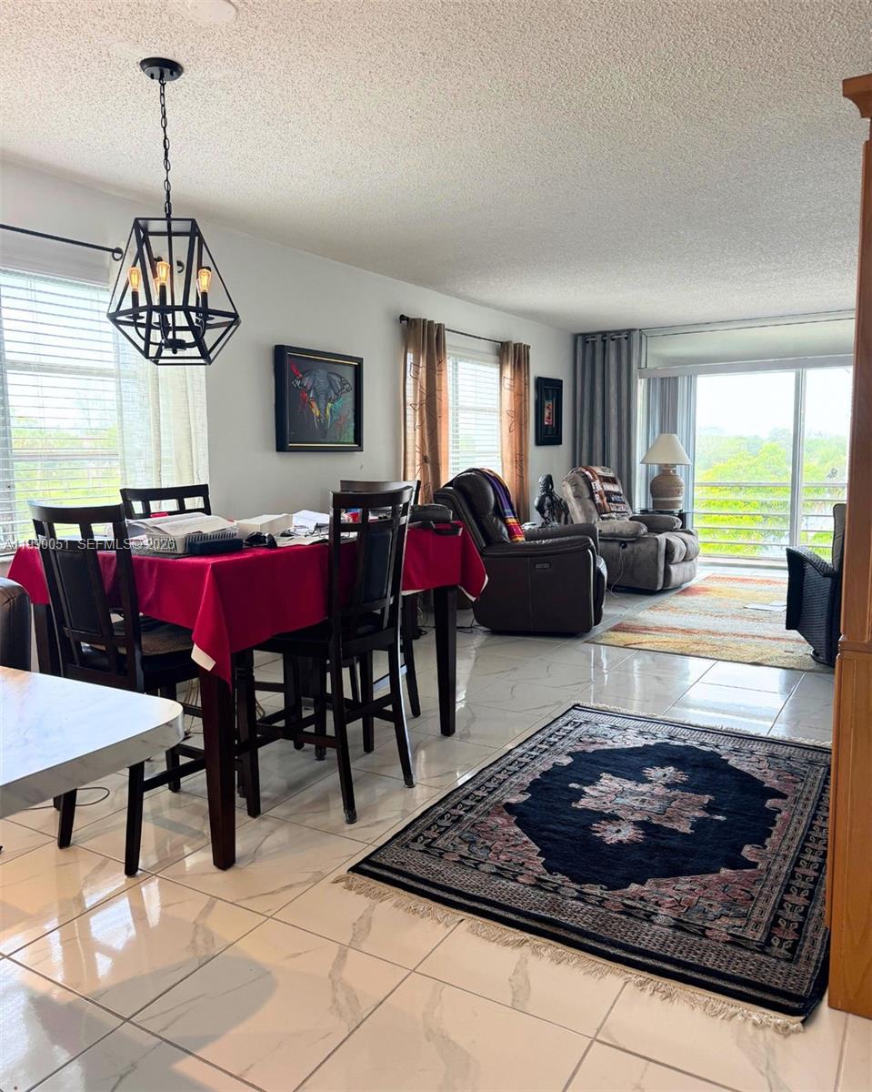 3776 Inverrary Boulevard, Unit 301R Lauderhill, FL 33319 - Photo 5 of 31 a living room with furniture and window
