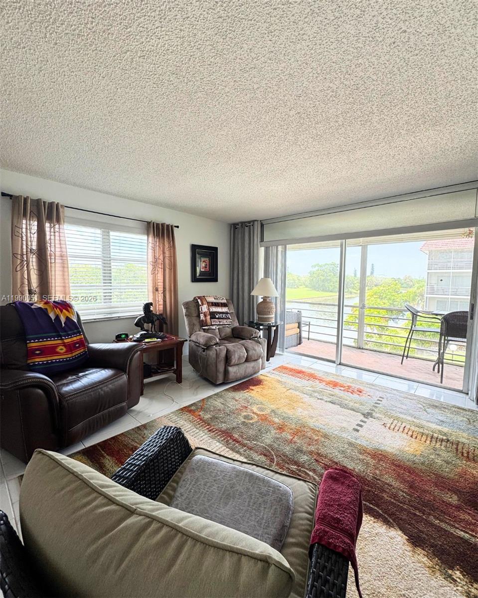 3776 Inverrary Boulevard, Unit 301R Lauderhill, FL 33319 - Photo 7 of 31 a living room with furniture and a large window