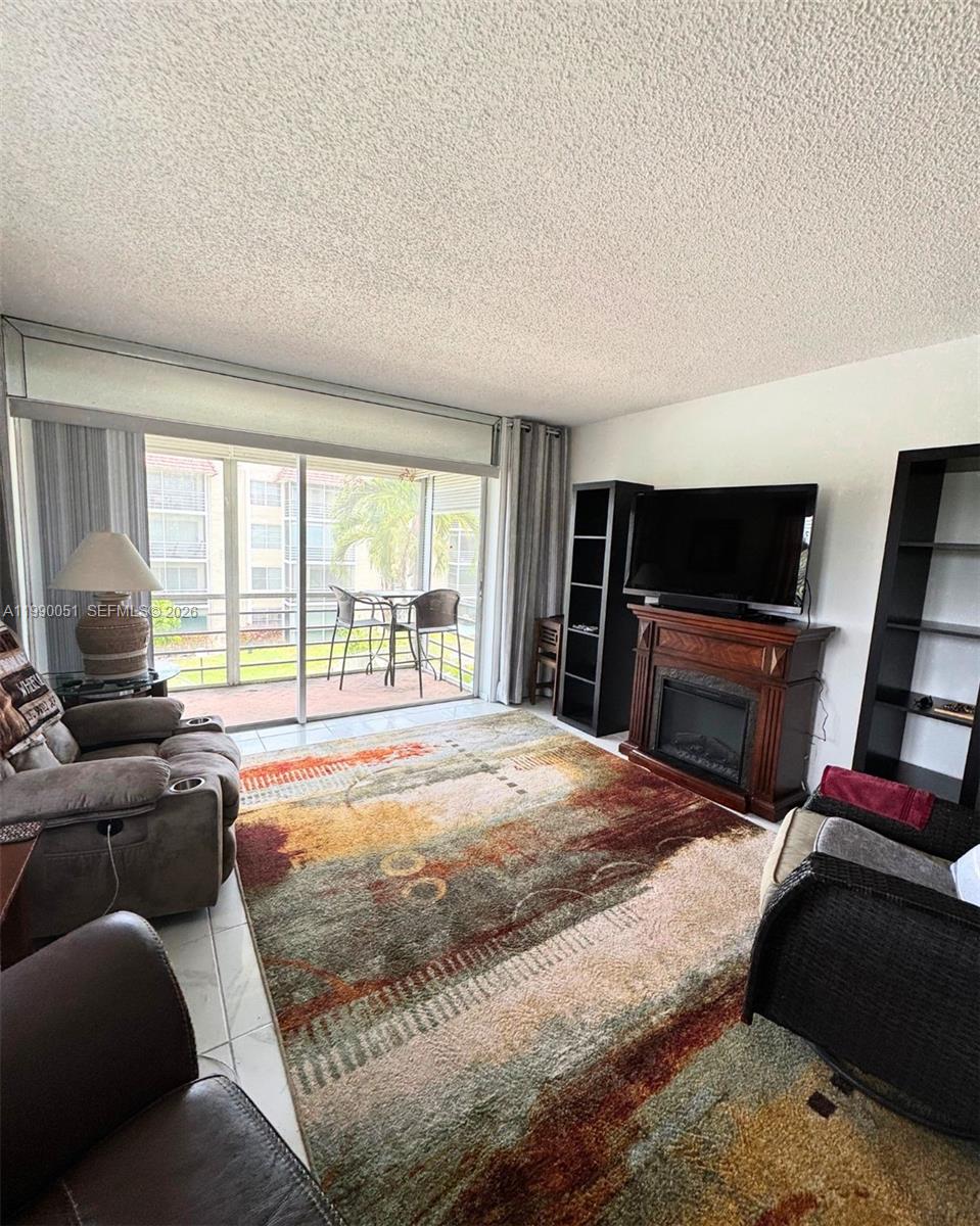 3776 Inverrary Boulevard, Unit 301R Lauderhill, FL 33319 - Photo 10 of 31 a bedroom with a bed and a television