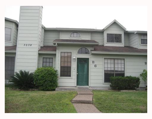 3038 Quail Springs Road, Unit B6 Corpus Christi, TX 78414 - Photo 1 of 7 a front view of a house with a garden