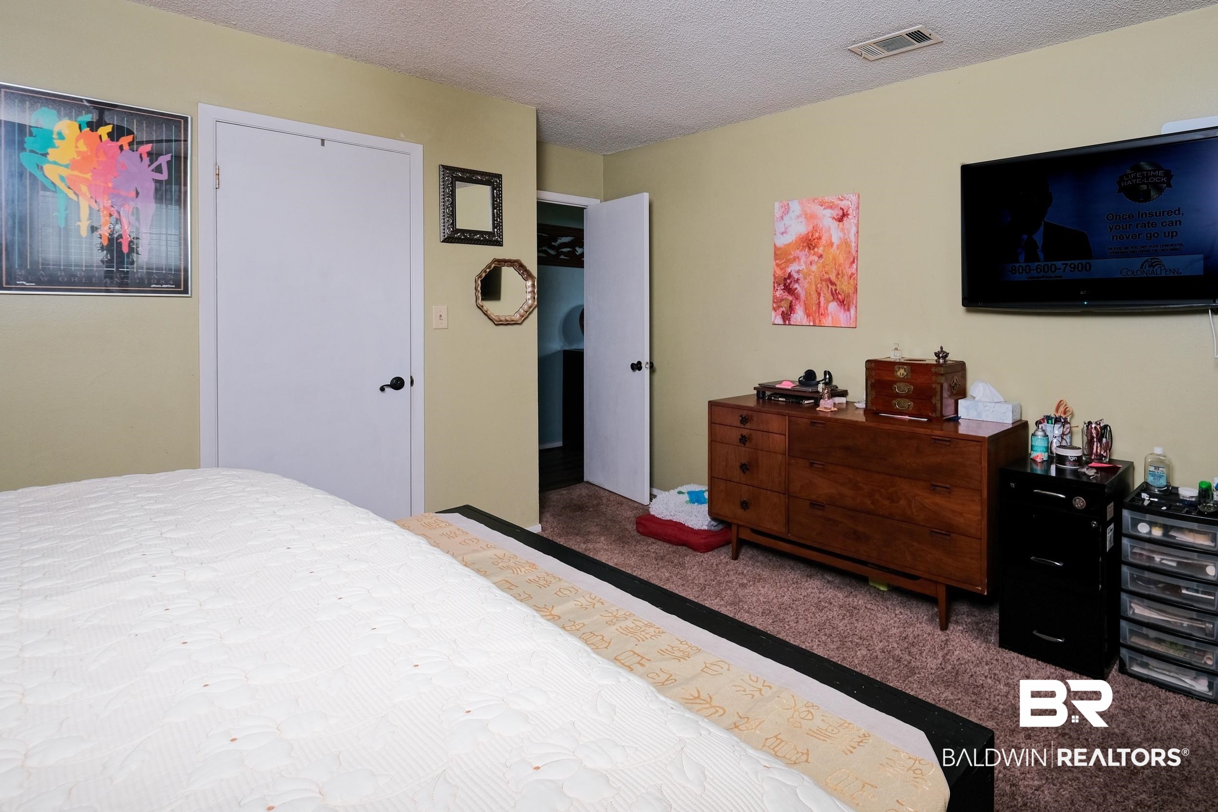 504 Ariel Avenue Foley, AL 36535 - Photo 23 of 33 Carpeted bedroom with a textured ceiling