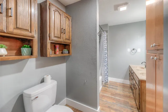 a kitchen with granite countertop a refrigerator and a sink