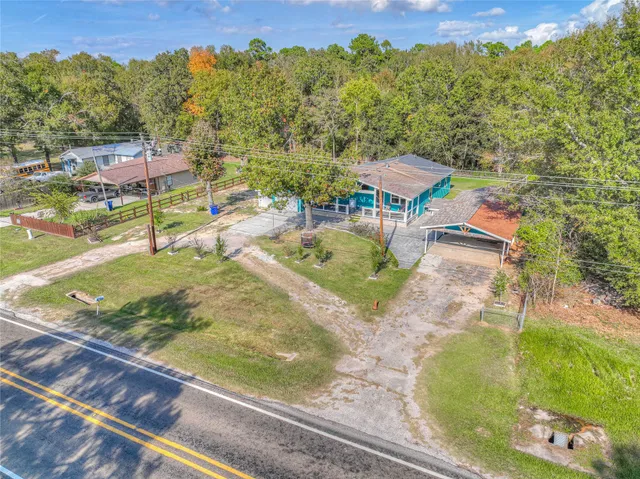 an aerial view of a house with a yard basket ball court and outdoor seating