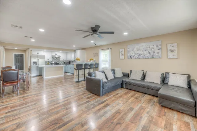 a living room with furniture and a ceiling fan