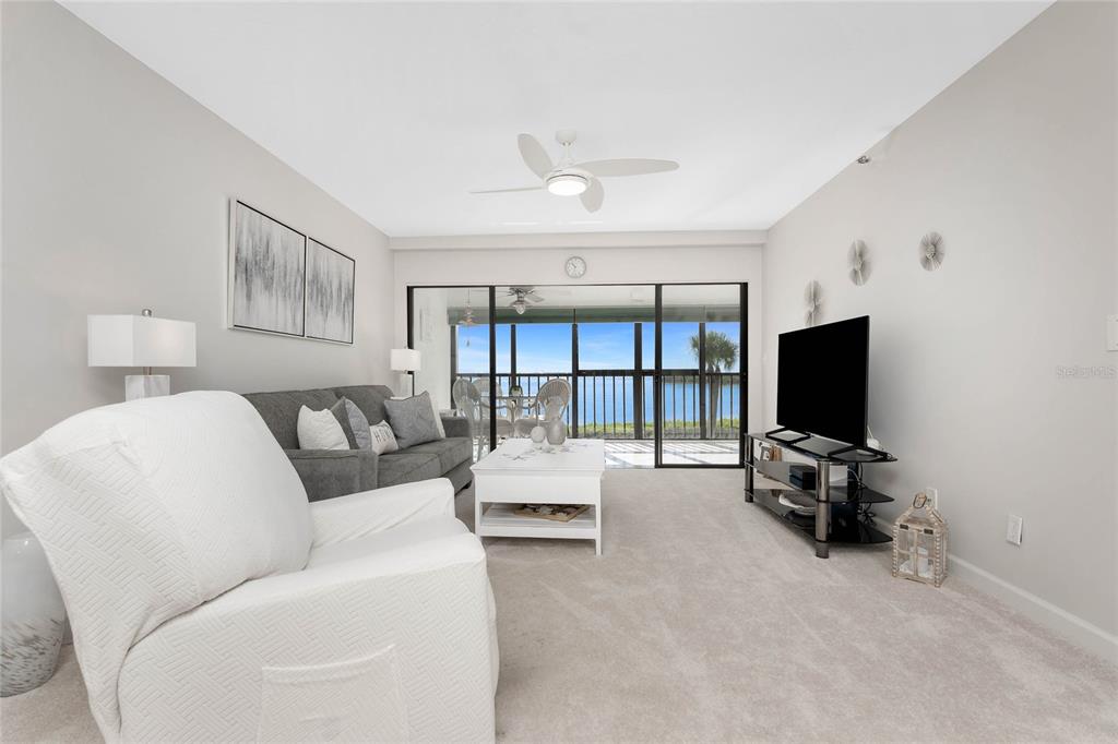 1551 Beach Road, Unit 306 Englewood, FL 34223 - Photo 11 of 50 a living room with furniture and a flat screen tv