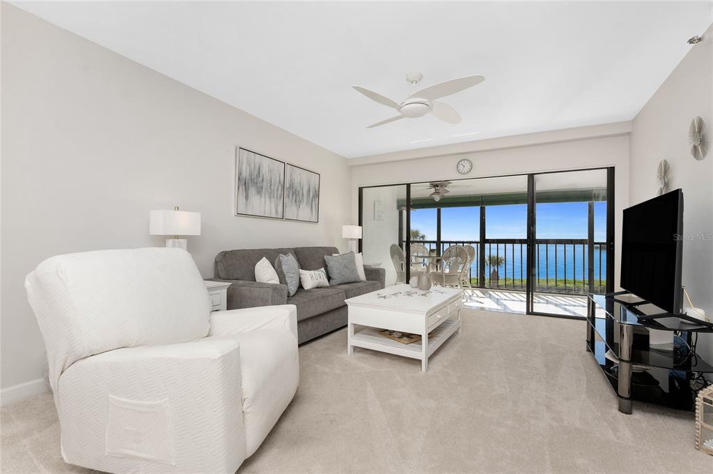 1551 Beach Road, Unit 306 Englewood, FL 34223 - Photo 14 of 50 a living room with furniture and a flat screen tv