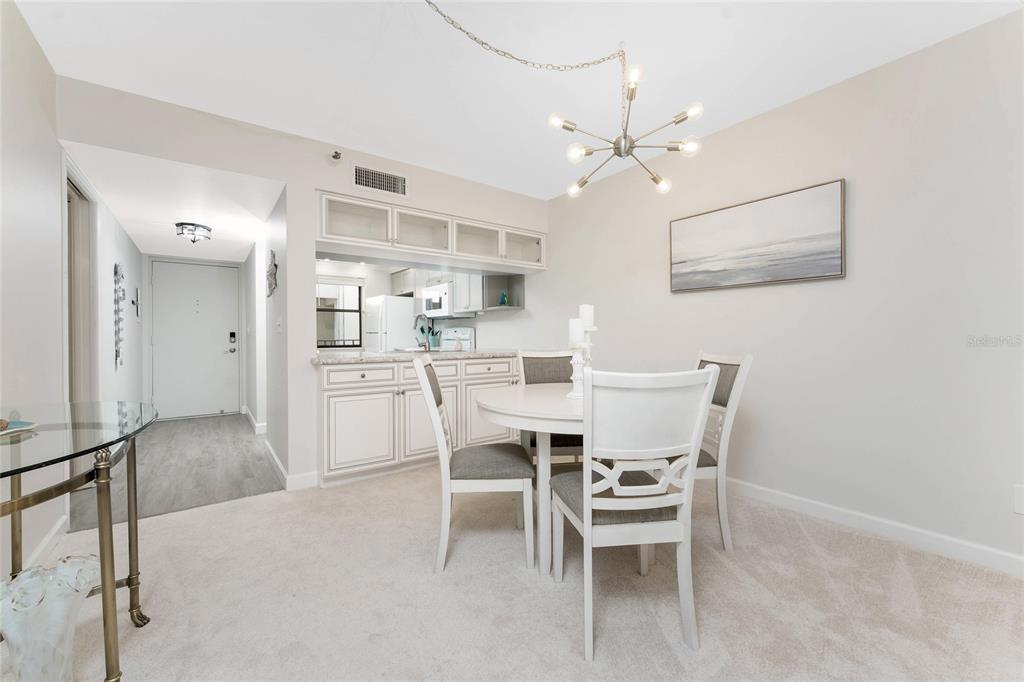 1551 Beach Road, Unit 306 Englewood, FL 34223 - Photo 18 of 50 a dining room with furniture and window