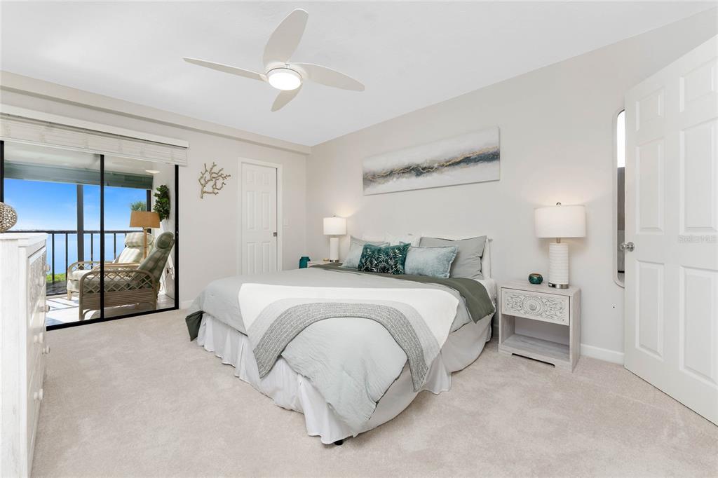 1551 Beach Road, Unit 306 Englewood, FL 34223 - Photo 23 of 50 a spacious bedroom with a bed and a lamp