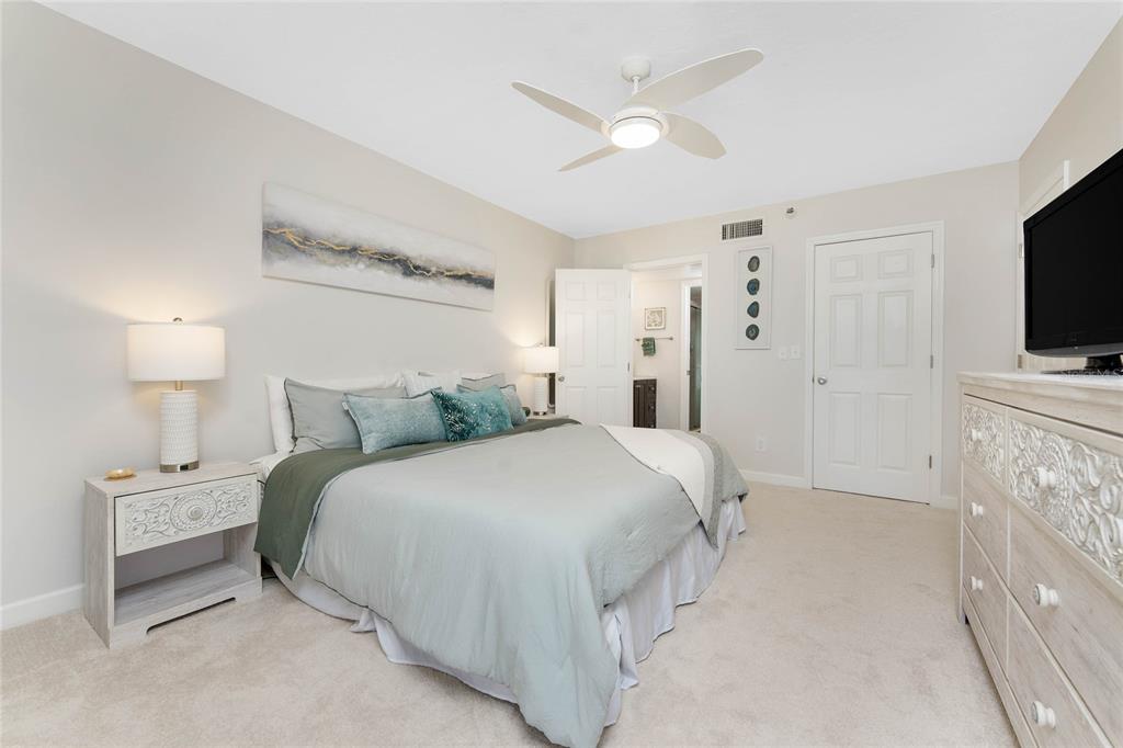 1551 Beach Road, Unit 306 Englewood, FL 34223 - Photo 25 of 50 a bedroom with a bed and a flat screen tv