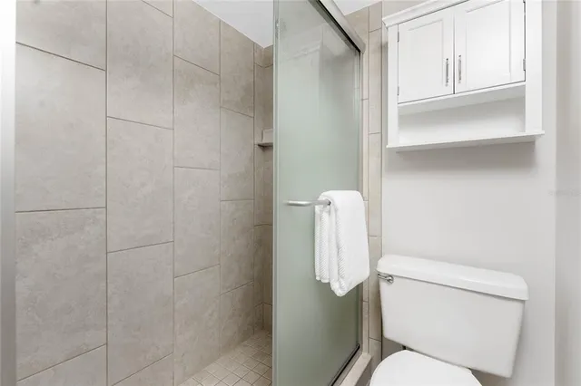 a white toilet sitting next to a bathroom sink