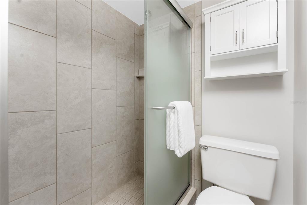 1551 Beach Road, Unit 306 Englewood, FL 34223 - Photo 29 of 50 a white toilet sitting next to a bathroom sink