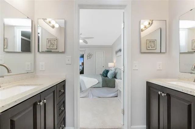 a bathroom with a sink vanity and mirror